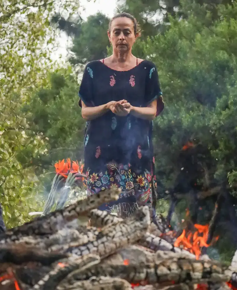 woman-over-ceremonial-fire woman standing over a ceremonial fire